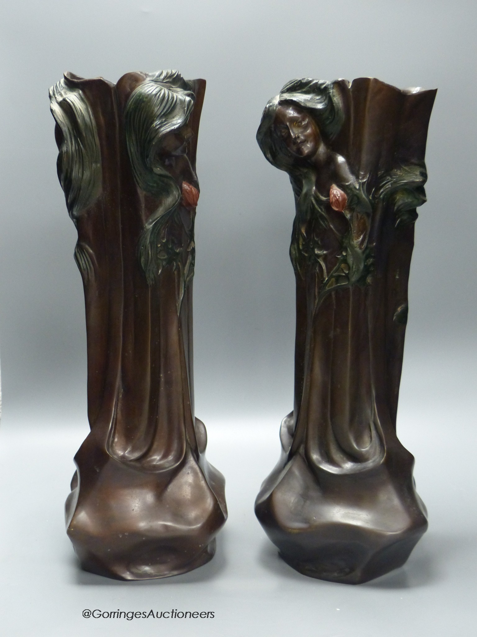 A pair of Art Nouveau style cold painted bronze figural vases, signed Flora, 42.5cm high